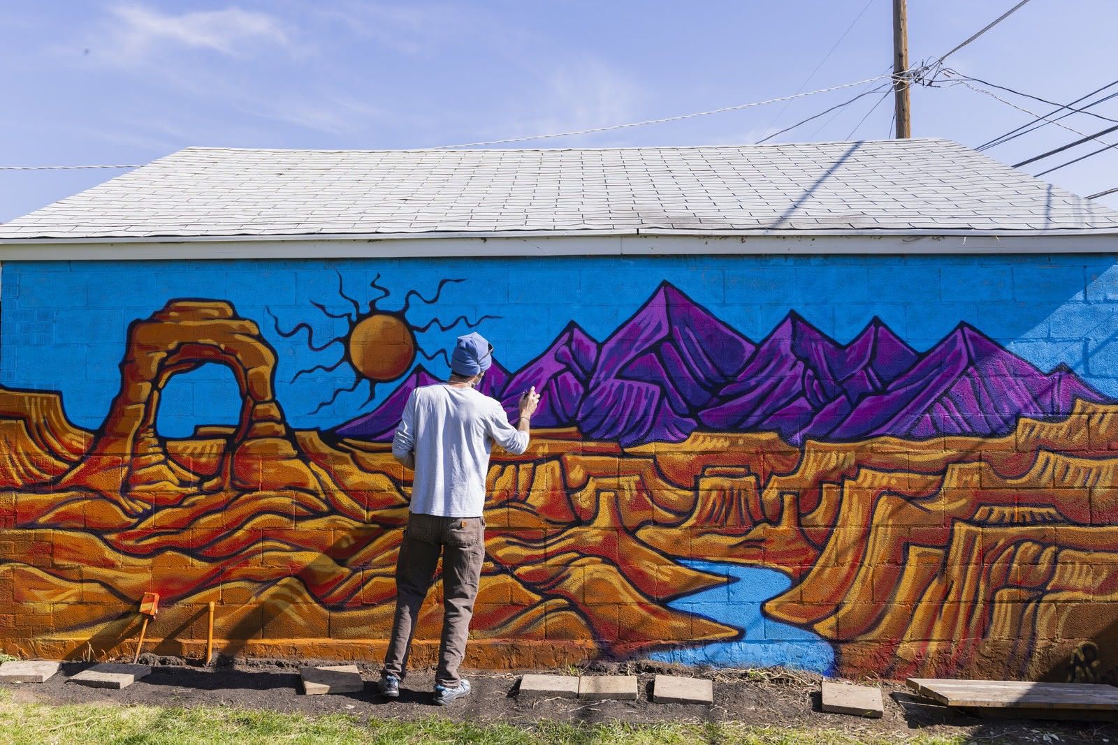 Andrew spray painting a mural