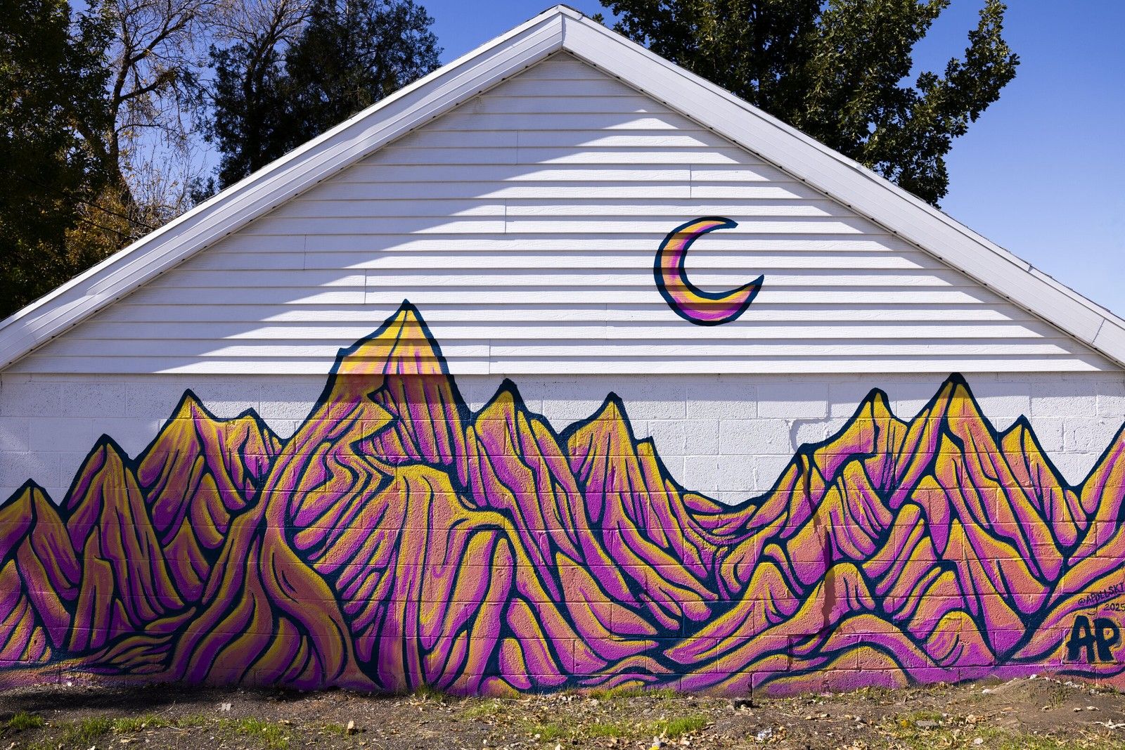 Mountain peaks mural on a garage
